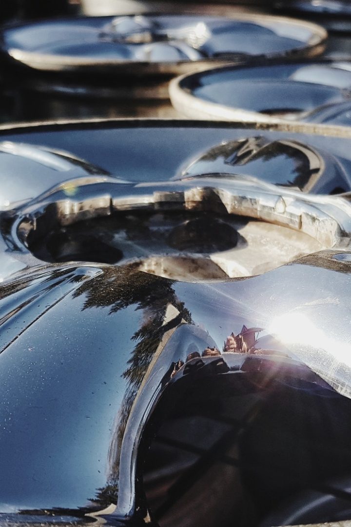 Closeup shot of an alloy wheel. Reflection on a chrome plated rim.